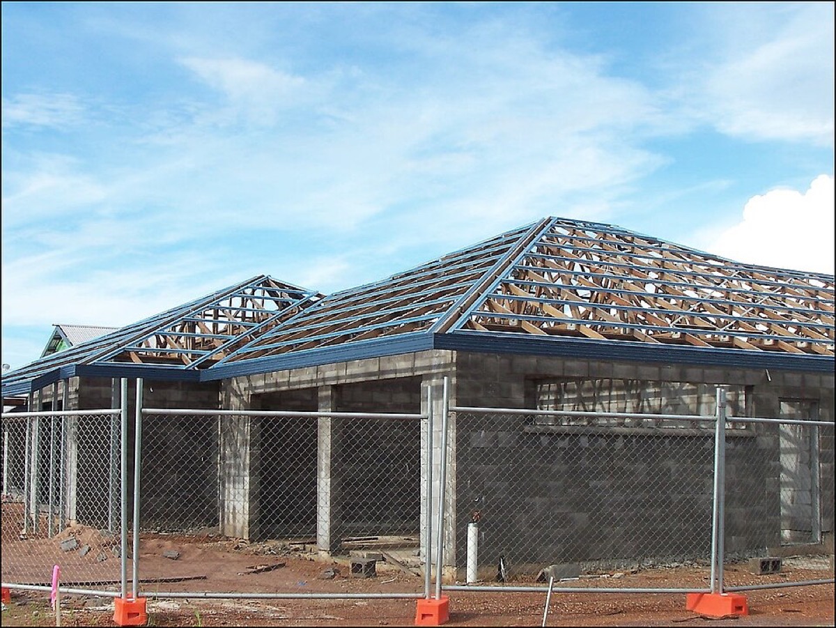 Hip roof construction showing roof trusses and metal battens or purlins